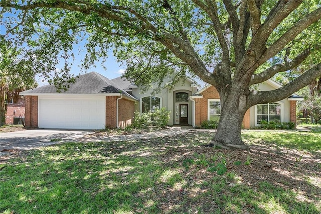 7218 Brookwood Dr, Mandeville, LA 70471 - view of front of home with an attached garage, brick siding, and concrete driveway
