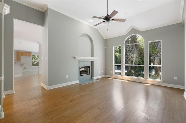 7218 Brookwood Dr, Mandeville, LA 70471 - unfurnished living room with healthy amount of natural light, a ceiling fan, light wood finished floors, a fireplace, and ornamental molding