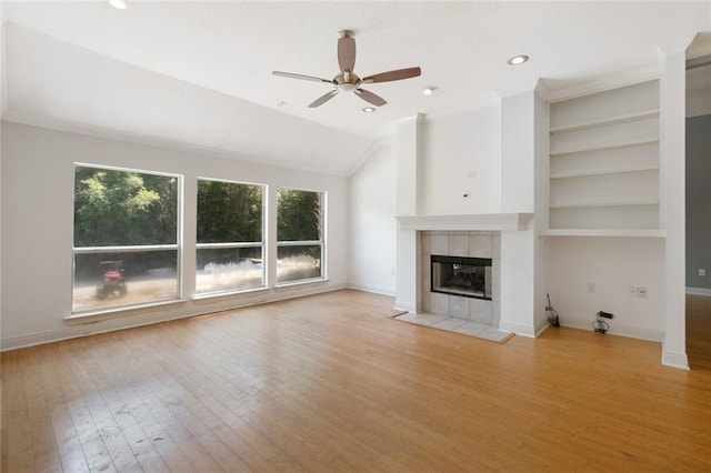 7218 Brookwood Dr, Mandeville, LA 70471 - unfurnished living room featuring a ceiling fan, a fireplace, wood finished floors, baseboards, and built in features