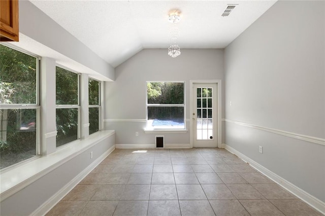 7218 Brookwood Dr, Mandeville, LA 70471 - unfurnished room with light tile patterned floors, a chandelier, vaulted ceiling, and baseboards