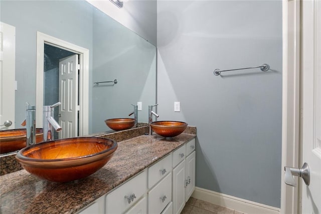 7218 Brookwood Dr, Mandeville, LA 70471 - bathroom featuring double vanity, tile patterned floors, and baseboards