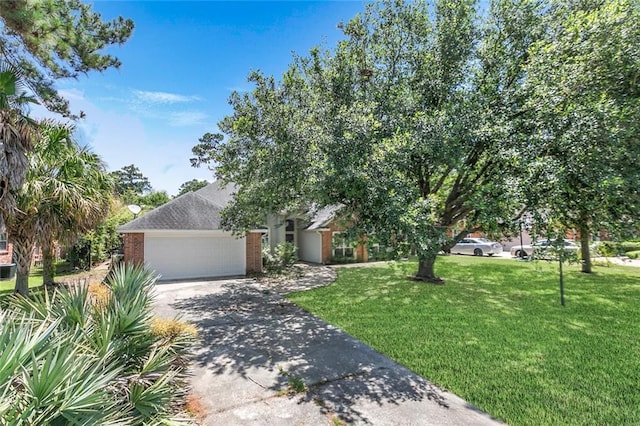 7218 Brookwood Dr, Mandeville, LA 70471 - obstructed view of property featuring a garage, concrete driveway, a front lawn, and brick siding