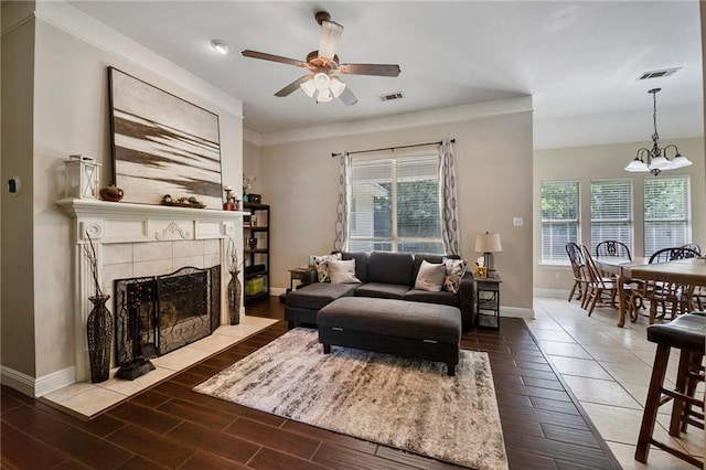72158 Mill Rd, Abita Springs, LA 70420 - living area featuring baseboards, ceiling fan, wood finished floors, a chandelier, and crown molding