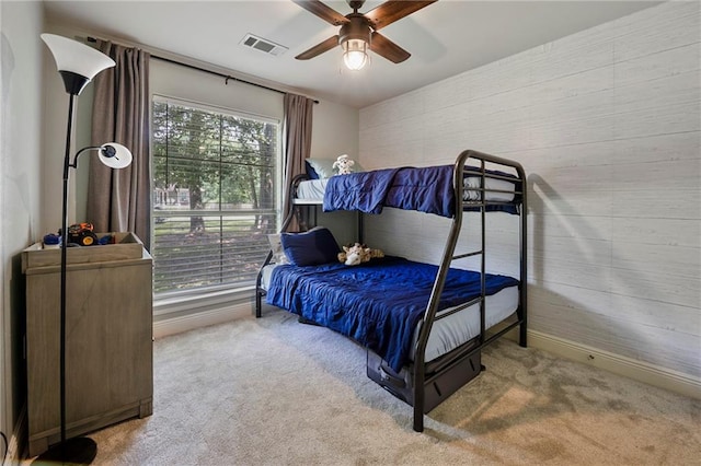 72158 Mill Rd, Abita Springs, LA 70420 - carpeted bedroom with ceiling fan, wooden walls, and baseboards