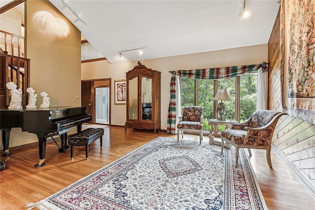 101 Lefleur Dr, Slidell, LA 70460 - sitting room featuring track lighting, stairway, wood finished floors, and vaulted ceiling