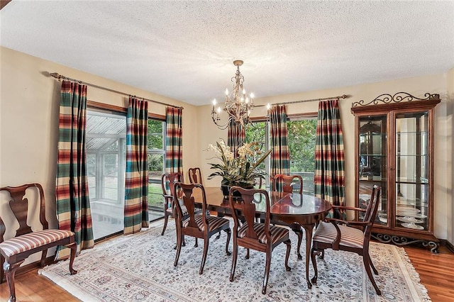 101 Lefleur Dr, Slidell, LA 70460 - dining space with a chandelier, light wood-style floors, and a textured ceiling