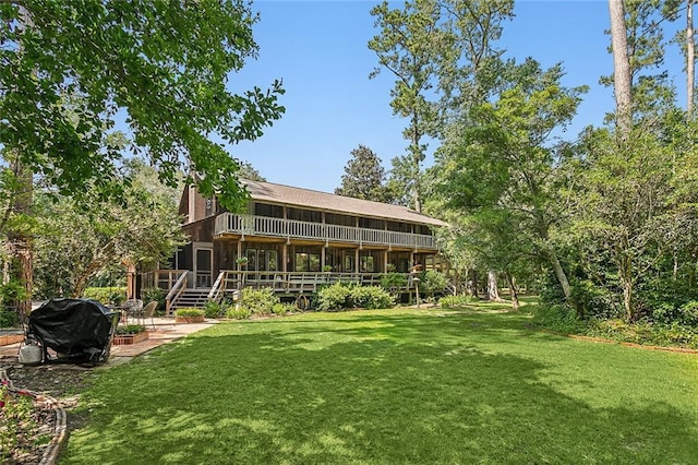 101 Lefleur Dr, Slidell, LA 70460 - back of property featuring a patio, a lawn, a wooden deck, and a sunroom