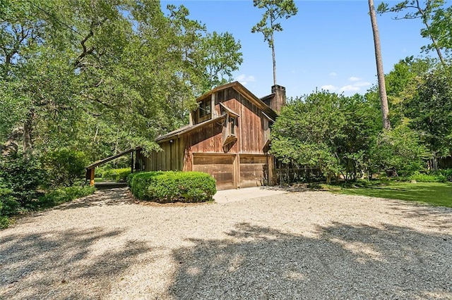 101 Lefleur Dr, Slidell, LA 70460 - view of side of property with a chimney, driveway, and an outdoor structure