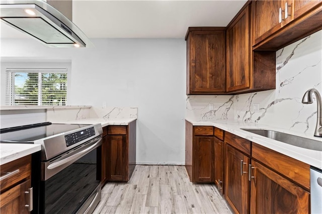 1037 Saint Joseph St, Slidell, LA 70460 - kitchen with stainless steel range with electric cooktop, a sink, light wood-type flooring, exhaust hood, and backsplash