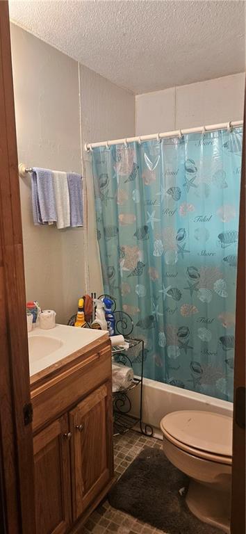 72422 Rose St, Covington, LA 70435 - bathroom with a textured ceiling, toilet, shower / tub combo with curtain, and vanity