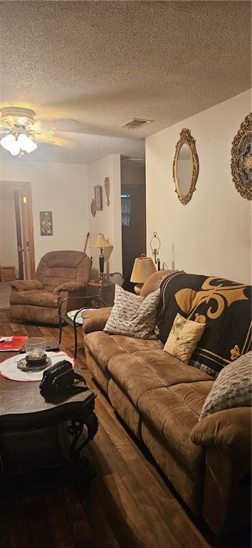 72422 Rose St, Covington, LA 70435 - living room with wood finished floors, a textured ceiling, and a ceiling fan