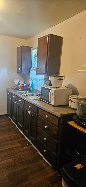 72422 Rose St, Covington, LA 70435 - kitchen with white microwave, dark wood-style floors, and dark brown cabinetry