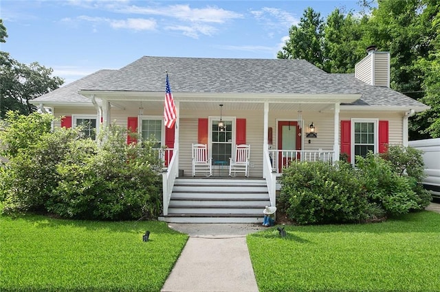220 Canulette Rd, Slidell, LA 70458 - bungalow-style house with a porch, a front lawn, a chimney, and a shingled roof