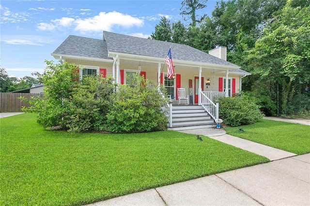 220 Canulette Rd, Slidell, LA 70458 - view of front of house featuring covered porch, a chimney, and roof with shingles