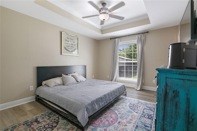220 Canulette Rd, Slidell, LA 70458 - bedroom featuring a raised ceiling, wood finished floors, crown molding, baseboards, and a ceiling fan