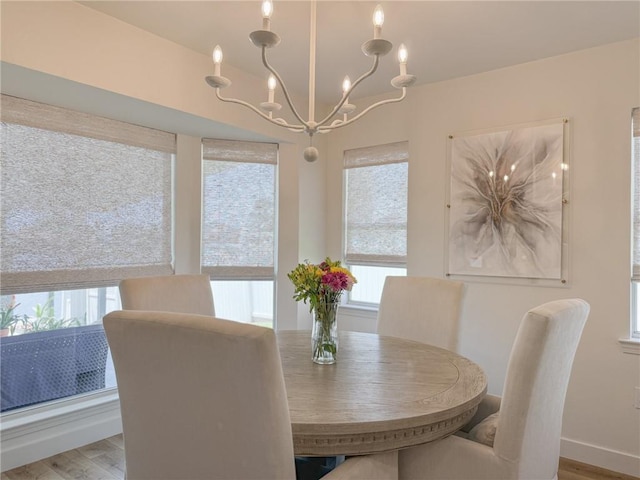 616 Marina Dr, Slidell, LA 70458 - dining room featuring plenty of natural light, a chandelier, wood finished floors, and baseboards