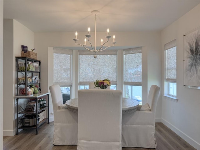 616 Marina Dr, Slidell, LA 70458 - dining space featuring a chandelier, wood finished floors, and baseboards