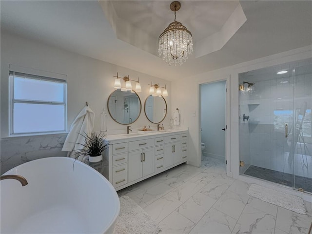 616 Marina Dr, Slidell, LA 70458 - bathroom featuring a chandelier, marble finish flooring, double vanity, and a freestanding tub