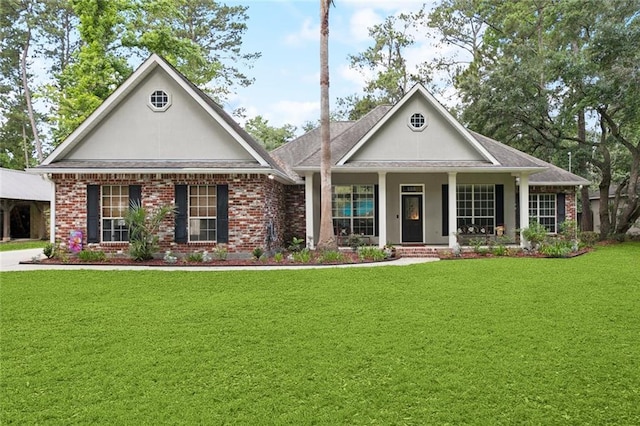 156 Egret St, Covington, LA 70433 - view of front facade featuring a front yard, a porch, stucco siding, and brick siding