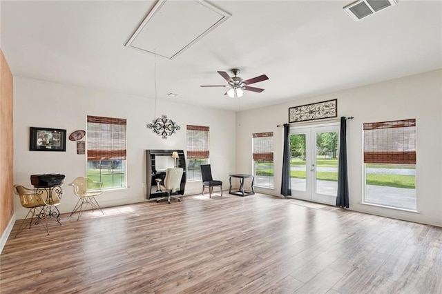 156 Egret St, Covington, LA 70433 - unfurnished room featuring attic access, wood finished floors, ceiling fan, and baseboards