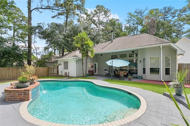 156 Egret St, Covington, LA 70433 - back of property featuring a fenced backyard, a patio area, and stucco siding