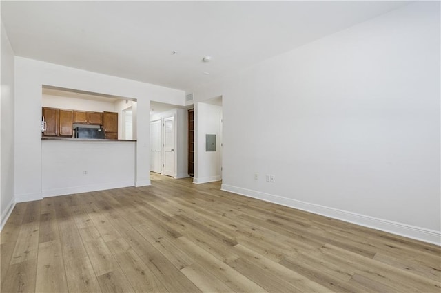 6765 Corporate Blvd Unit 11102, Baton Rouge, LA 70809 - unfurnished living room with light wood-type flooring, baseboards, and electric panel