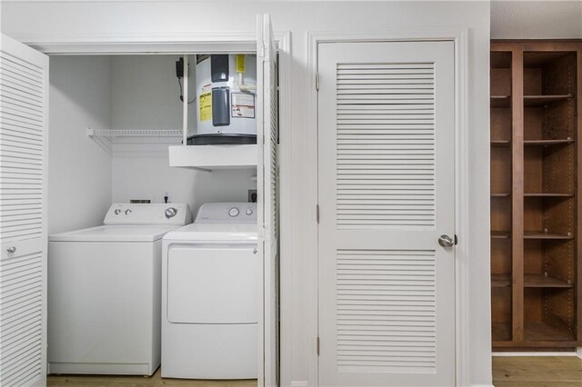 6765 Corporate Blvd Unit 11102, Baton Rouge, LA 70809 - washroom with washer and clothes dryer and light wood-type flooring