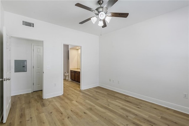 6765 Corporate Blvd Unit 11102, Baton Rouge, LA 70809 - unfurnished bedroom featuring electric panel, light wood-style floors, baseboards, connected bathroom, and ceiling fan