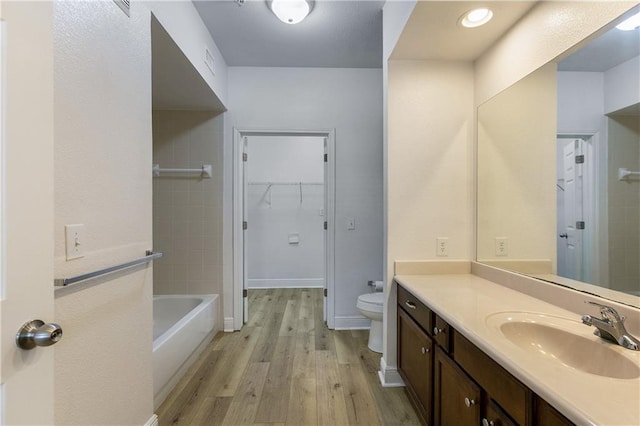 6765 Corporate Blvd Unit 11102, Baton Rouge, LA 70809 - bathroom with vanity, toilet, wood finished floors, and a walk in closet
