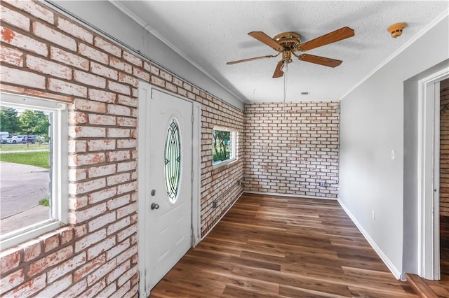30425 Eden Church Rd, Denham Springs, LA 70726 - entrance foyer with brick wall, a ceiling fan, ornamental molding, wood finished floors, and a textured ceiling