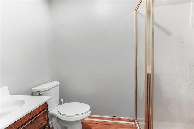 30425 Eden Church Rd, Denham Springs, LA 70726 - bathroom with vanity, a shower stall, toilet, and wood finished floors