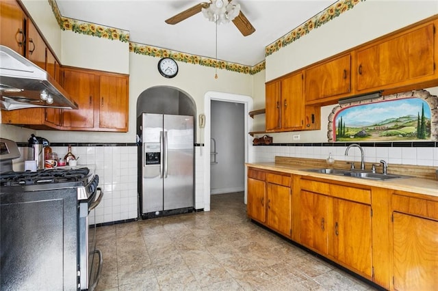 1706 Metairie Rd, Metairie, LA 70005 - kitchen featuring appliances with stainless steel finishes, a sink, exhaust hood, ceiling fan, and brown cabinetry