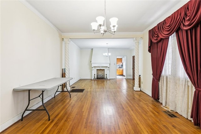 1706 Metairie Rd, Metairie, LA 70005 - living area featuring a chandelier, decorative columns, hardwood / wood-style flooring, crown molding, and baseboards