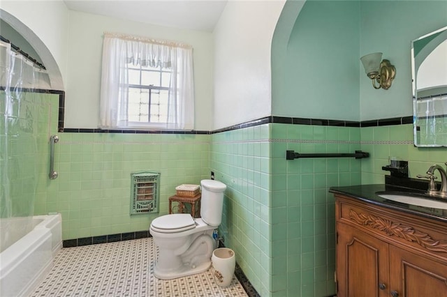 1706 Metairie Rd, Metairie, LA 70005 - bathroom with heating unit, toilet, tile walls, vanity, and wainscoting