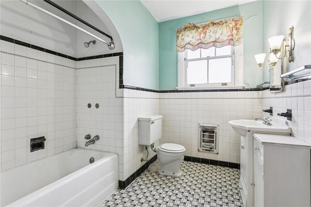 1706 Metairie Rd, Metairie, LA 70005 - bathroom with heating unit, vanity, toilet, tub / shower combination, and tile walls