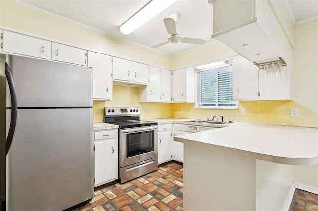 106 Matthews Dr, Slidell, LA 70458 - kitchen featuring stainless steel appliances, brick floors, crown molding, a peninsula, and white cabinetry