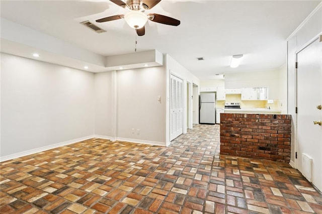 106 Matthews Dr, Slidell, LA 70458 - unfurnished living room with brick flooring, ceiling fan, and recessed lighting