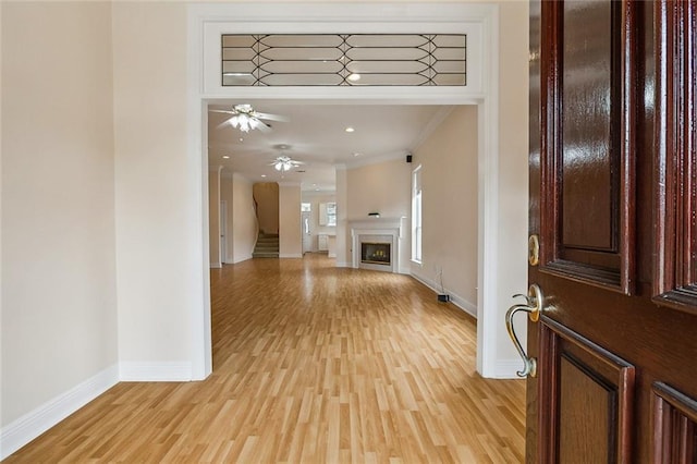 1715 Demosthenes St, Metairie, LA 70005 - entryway with crown molding, baseboards, light wood-style floors, and a fireplace