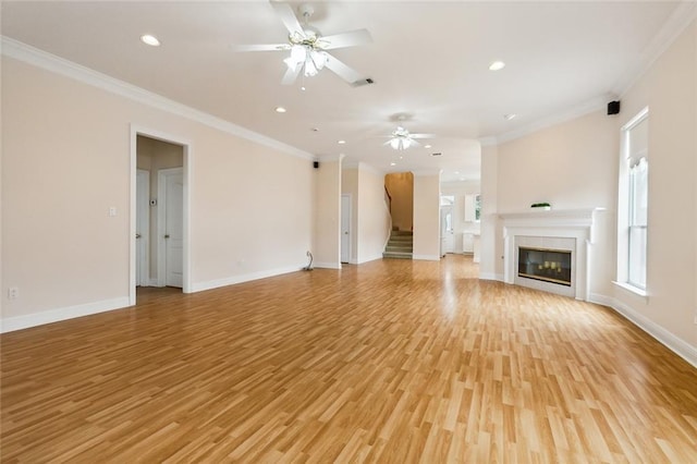 1715 Demosthenes St, Metairie, LA 70005 - unfurnished living room featuring crown molding, light wood finished floors, a ceiling fan, stairs, and baseboards