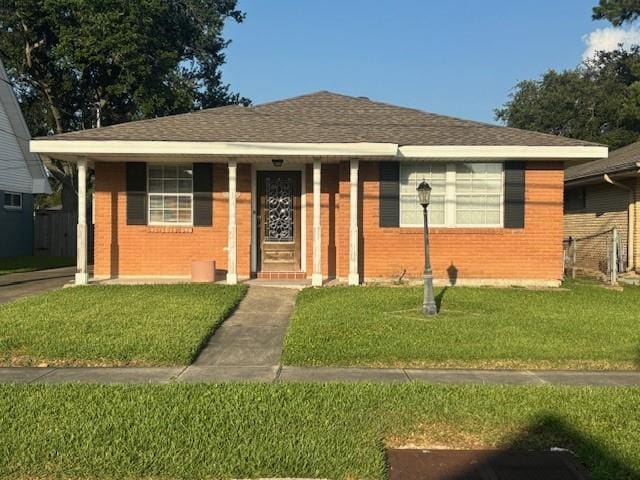 3107 Metairie Heights Ave, Metairie, LA 70002 - bungalow-style home with a front lawn, brick siding, a shingled roof, and a porch