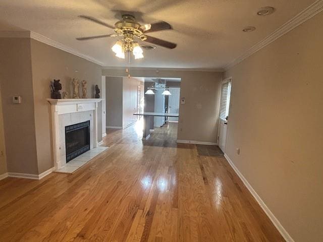 3107 Metairie Heights Ave, Metairie, LA 70002 - unfurnished living room featuring a ceiling fan, light wood-type flooring, baseboards, crown molding, and a fireplace
