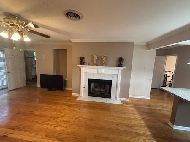 3107 Metairie Heights Ave, Metairie, LA 70002 - unfurnished living room featuring a ceiling fan, ornamental molding, baseboards, light wood finished floors, and a fireplace