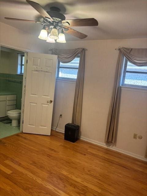 3107 Metairie Heights Ave, Metairie, LA 70002 - unfurnished bedroom with multiple windows, light wood-style floors, and ensuite bathroom