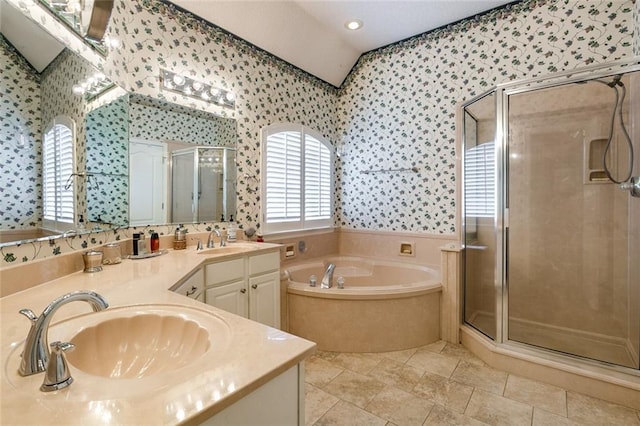 219 Bamboo Dr, Covington, LA 70433 - full bath featuring wallpapered walls, double vanity, a garden tub, a stall shower, and vaulted ceiling