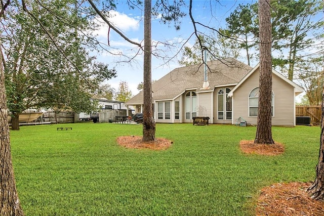 219 Bamboo Dr, Covington, LA 70433 - rear view of house featuring central AC and a shingled roof