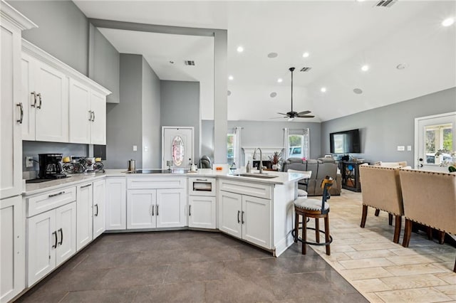 212 W Field Ct, Mandeville, LA 70471 - kitchen with a peninsula, a ceiling fan, light countertops, white cabinets, and recessed lighting