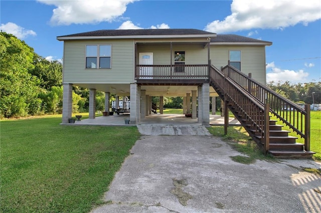 2634 Privateer Blvd, Barataria, LA 70036 - beach home with a carport, driveway, stairway, and a front lawn