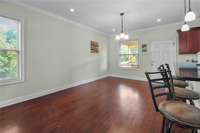 2634 Privateer Blvd, Barataria, LA 70036 - dining area with dark wood-type flooring, crown molding, recessed lighting, and a chandelier