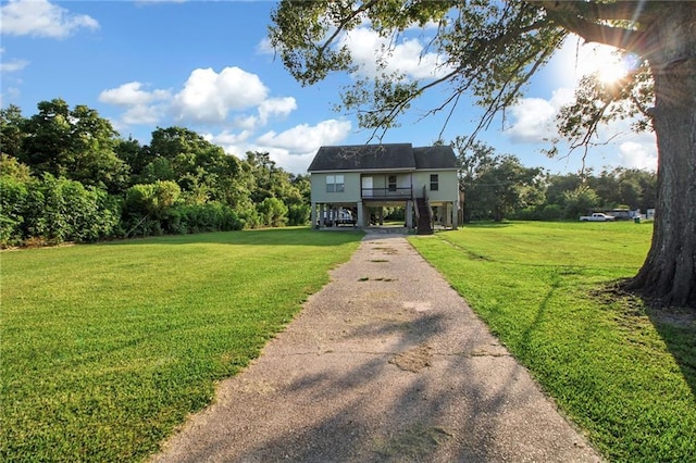 2634 Privateer Blvd, Barataria, LA 70036 - coastal inspired home with asphalt driveway, a front yard, a carport, and stairway