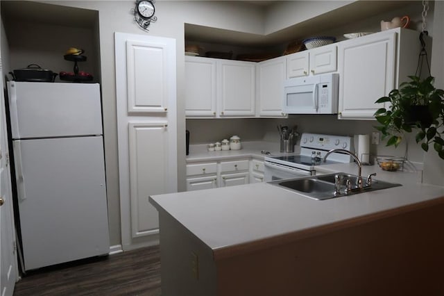 350 Emerald Forest Blvd Unit 17103, Covington, LA 70433 - kitchen featuring white appliances, a peninsula, white cabinets, dark wood-style flooring, and light countertops